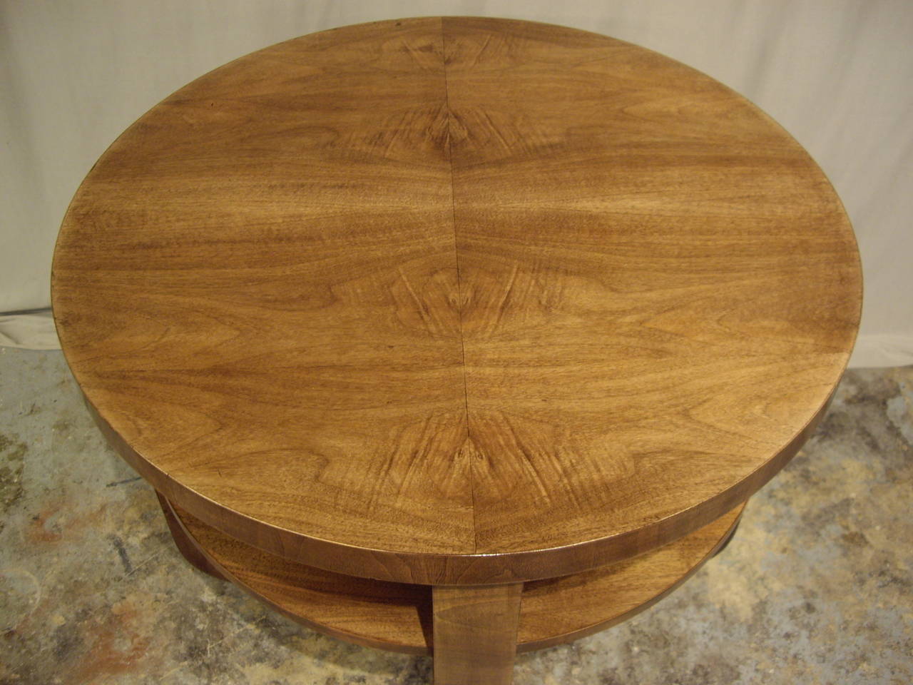 Elegant walnut French Art Deco round table. Can be used as a side table for sofa or pair of chairs or center hall table. Carefully restored and French polished.