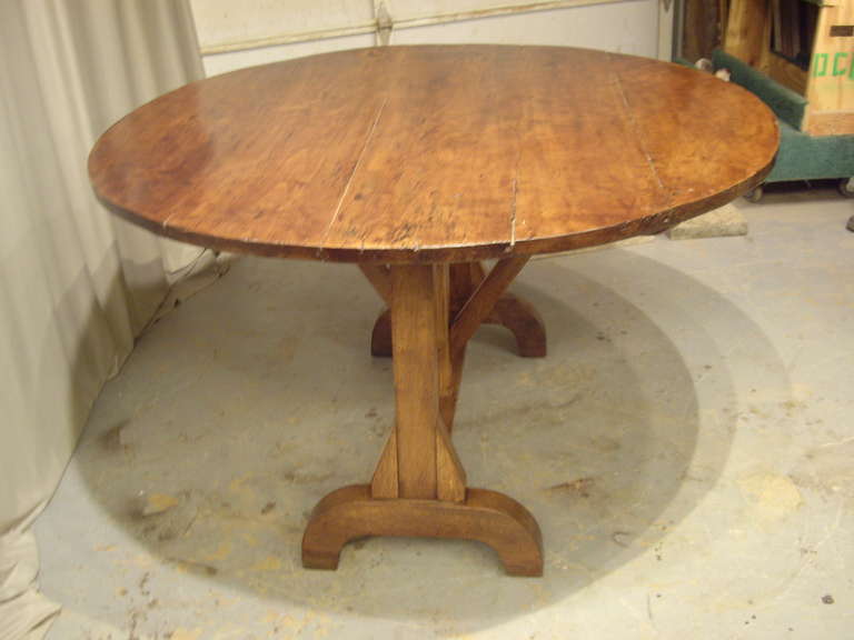 Beautiful round French Provincial  wine table. The round top is walnut and the base is a thick solid oak.  Expertly restored with warm patina.