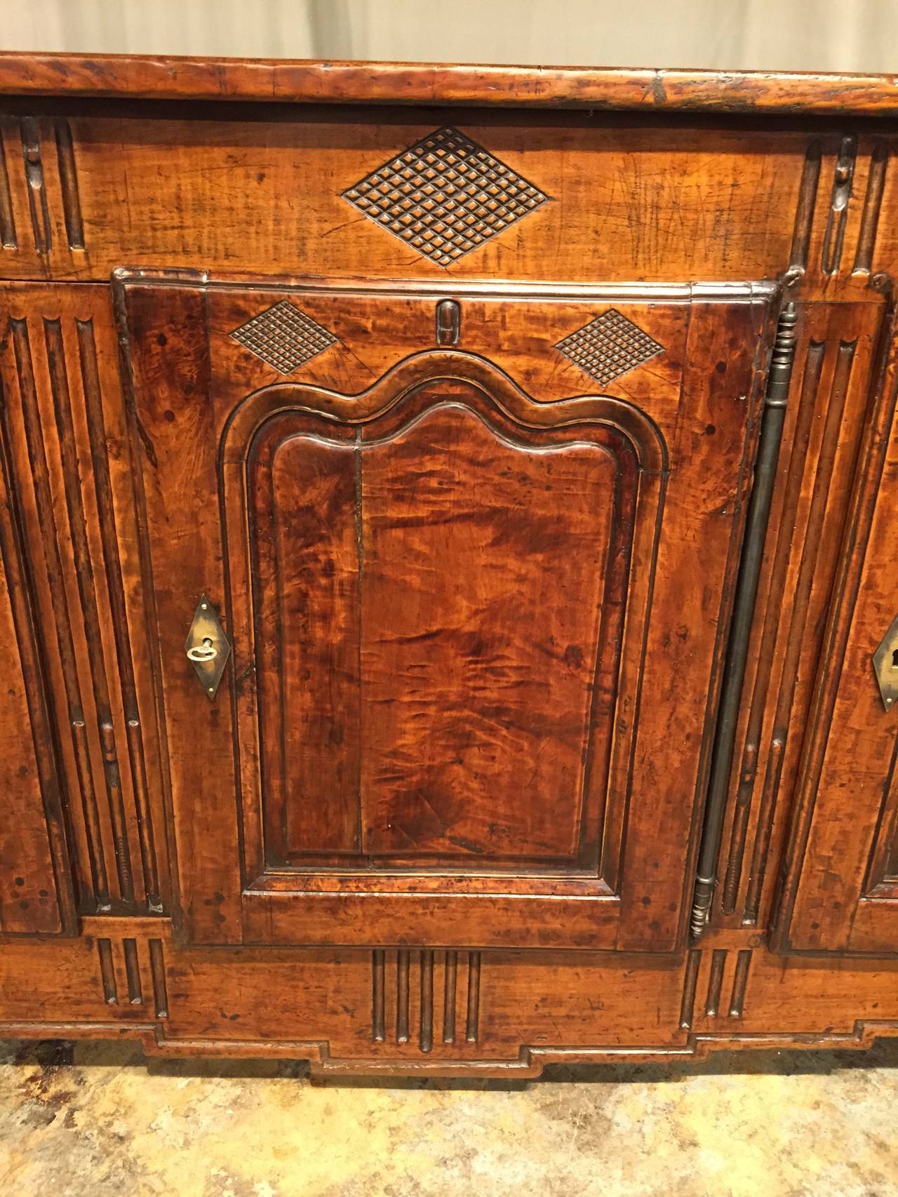 French Provincial transitional Louis XVI Directoire three-door enfilade. Walnut body with chestnut top. Beautiful warm patina that has been carefully restored.
