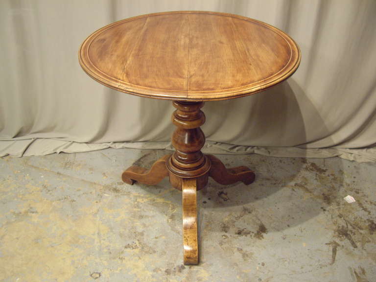 Beautiful 19th century French tripod pedestal walnut table. Lovely carved top and turned pedestal.  Very nice warm honey colored patina.