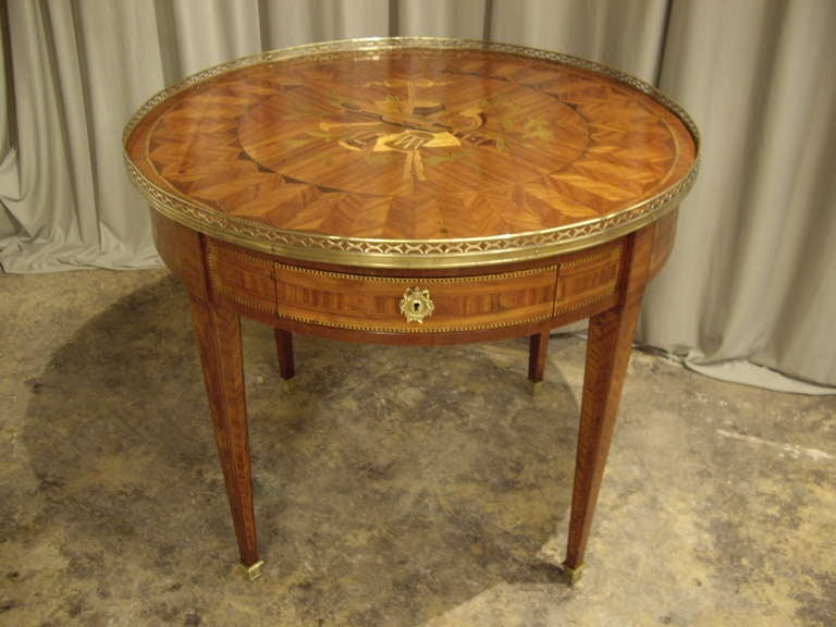 Beautiful large inlaid French bouillotte  table depicting musical  instruments.  Has two candlestick sides on each side and bronze gallery.