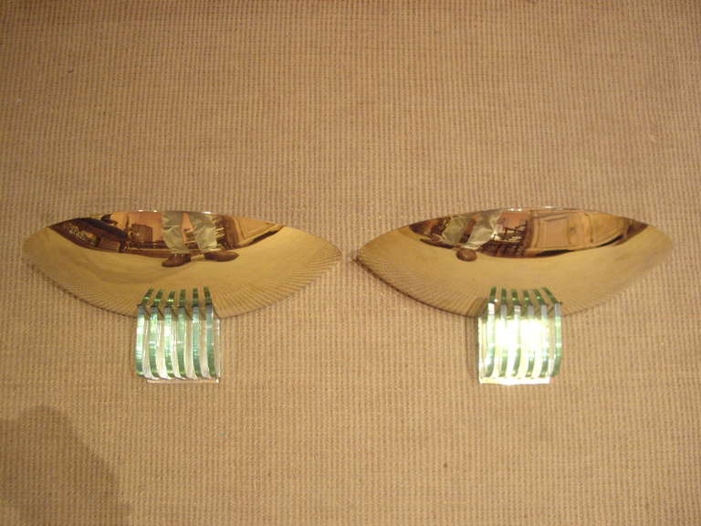 Pair of vintage French brass and glass wall sconces. The lite shows through the bottom to reflect on the glass.  Wired for US