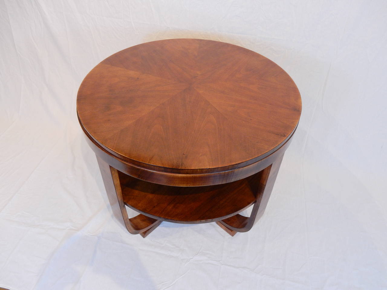 Elegant round Art Deco walnut table. Very nice patina and warm color. Carefully restored.
