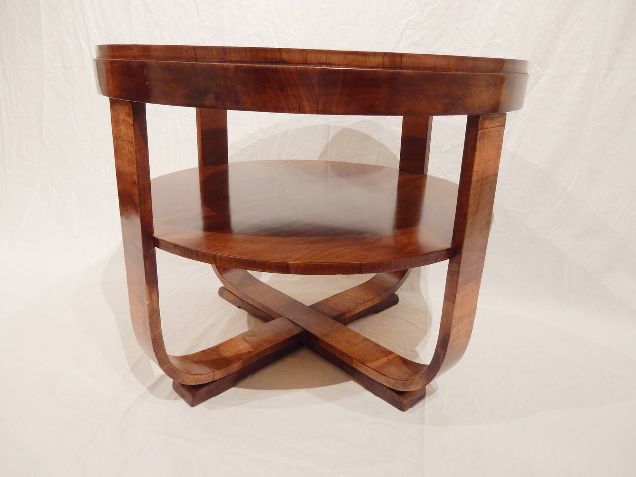 Elegant round Art Deco walnut occasional table with shelf. Very nice patina.