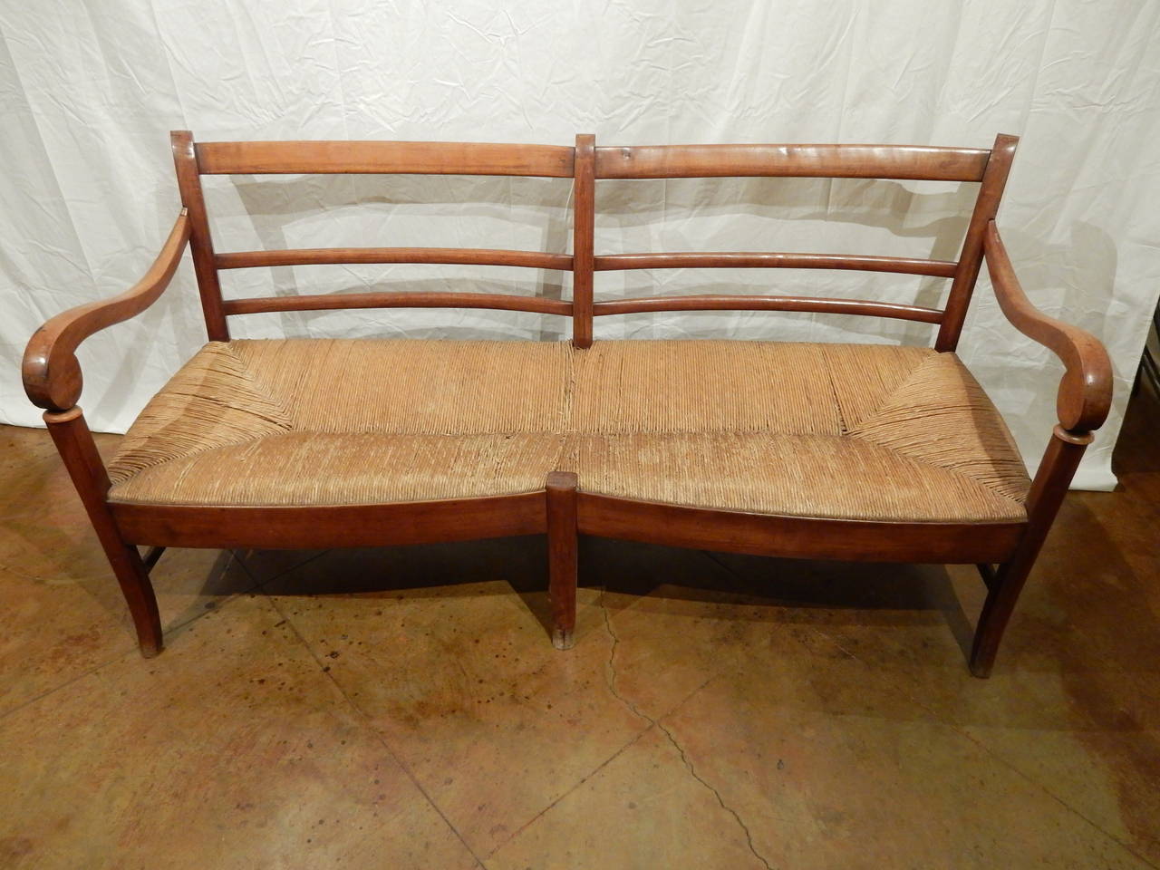 Large French Provincial walnut 19th century banquette with rush seat. Would be wonderful sofa with large cushion and pillows. Has enough depth to be very comfortable.