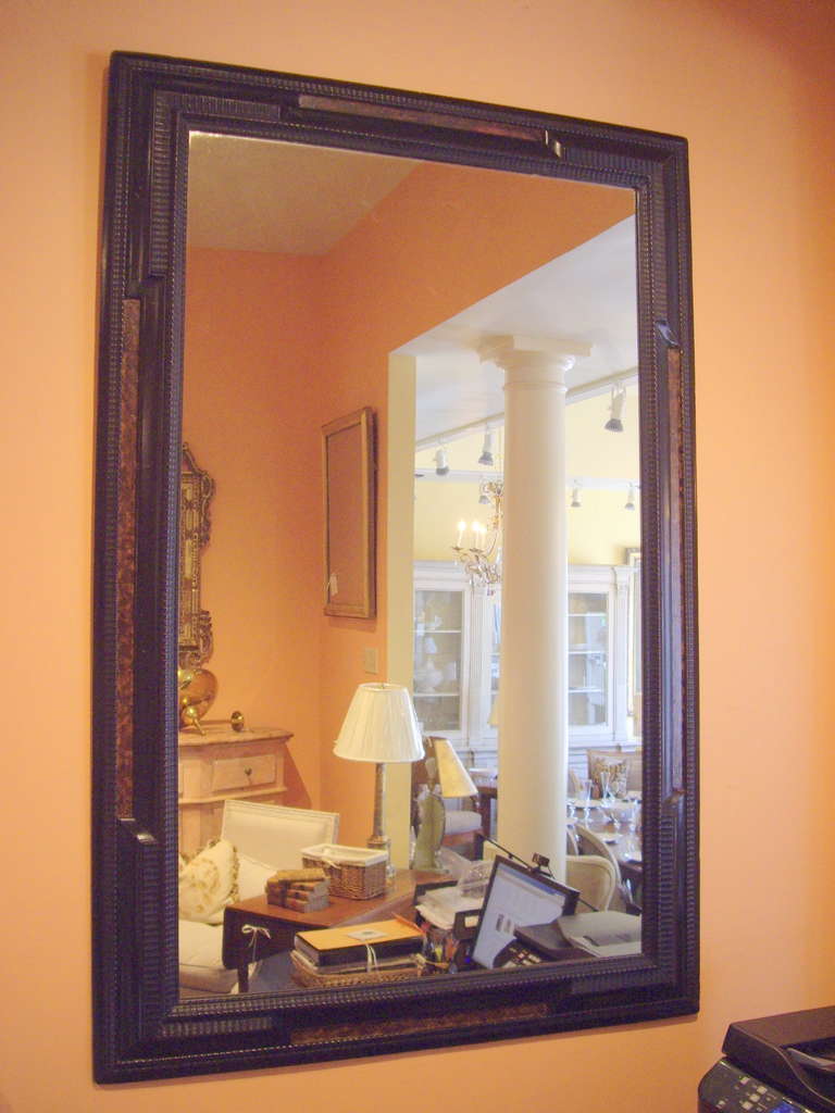 Late 19th c. Dutch style black and faux tortoise Dutch mirror.