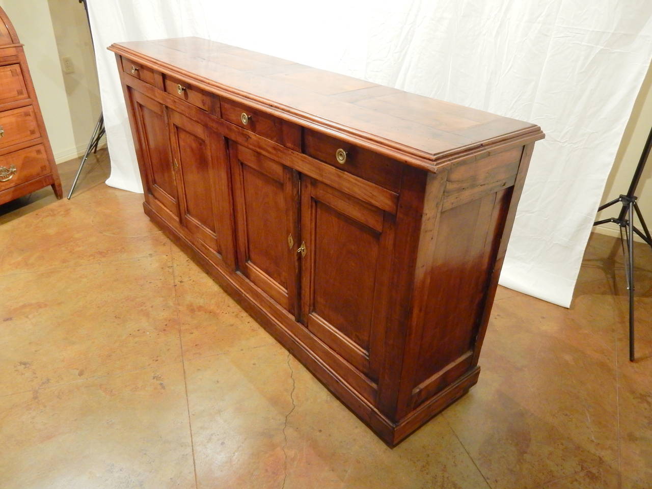 Long narrow French 19th century walnut four-door and four-drawer enfilade. Carefully restored to maintain it's warm patina.