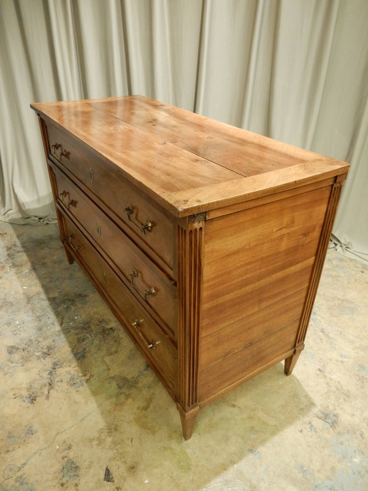 Beautifully and carefully restored Directoire walnut three drawer commode.