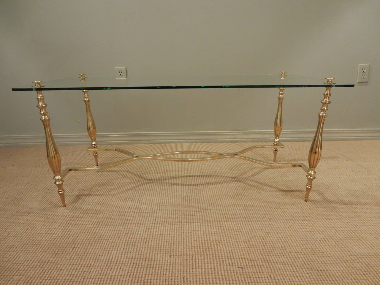 Traditional stylized brass and glass vintage French coffee table.
