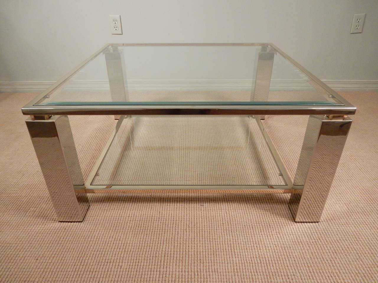 Square 1960's French chrome, glass and brass trimmed coffee table with beveled glass top and shelf.