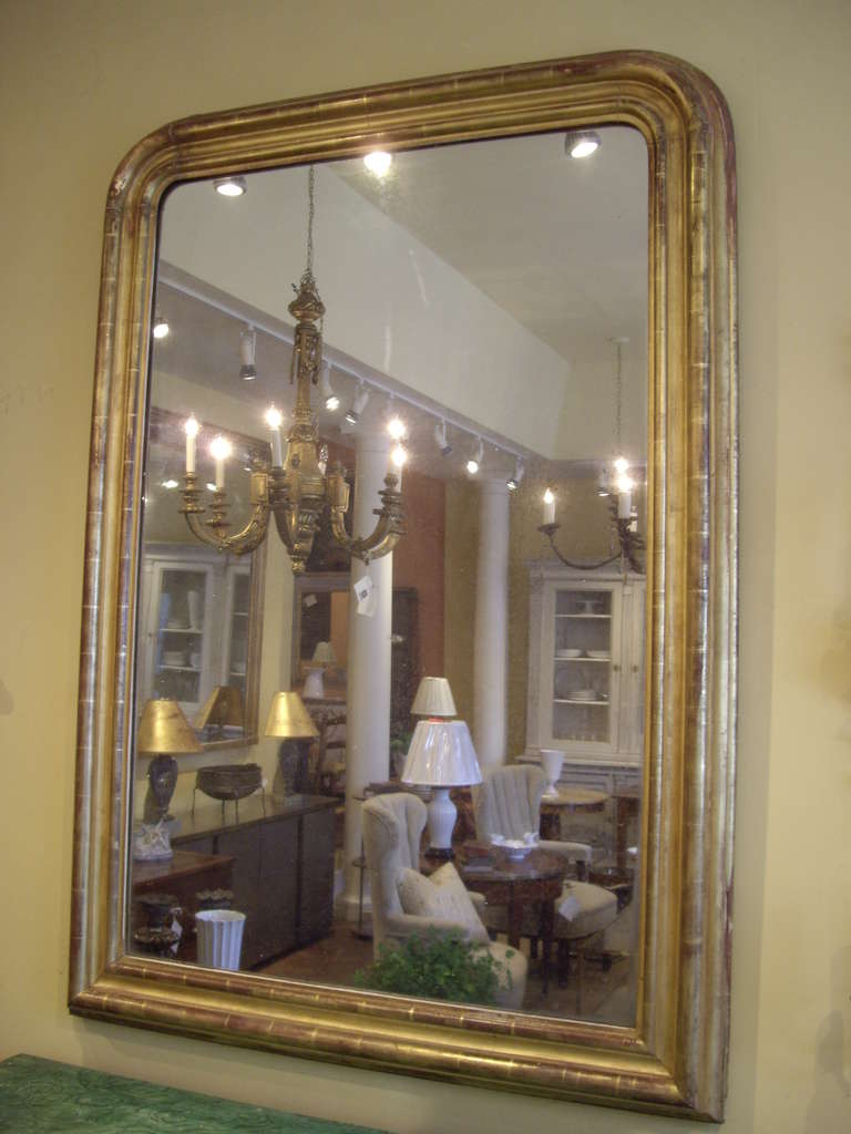 Large gold gilt 19th century Louis Philippe mirror with original mercury glass.  Lovely worn gilt patina.