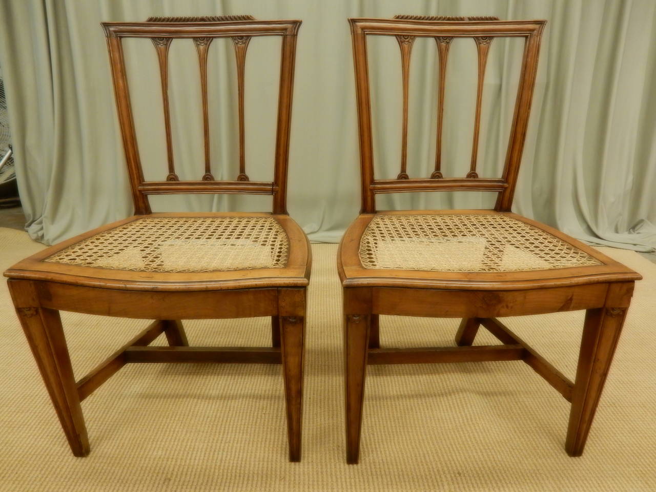 Carefully restored 19th century walnut Italian carved dining chairs. Chairs need cushions on the canned seats.
