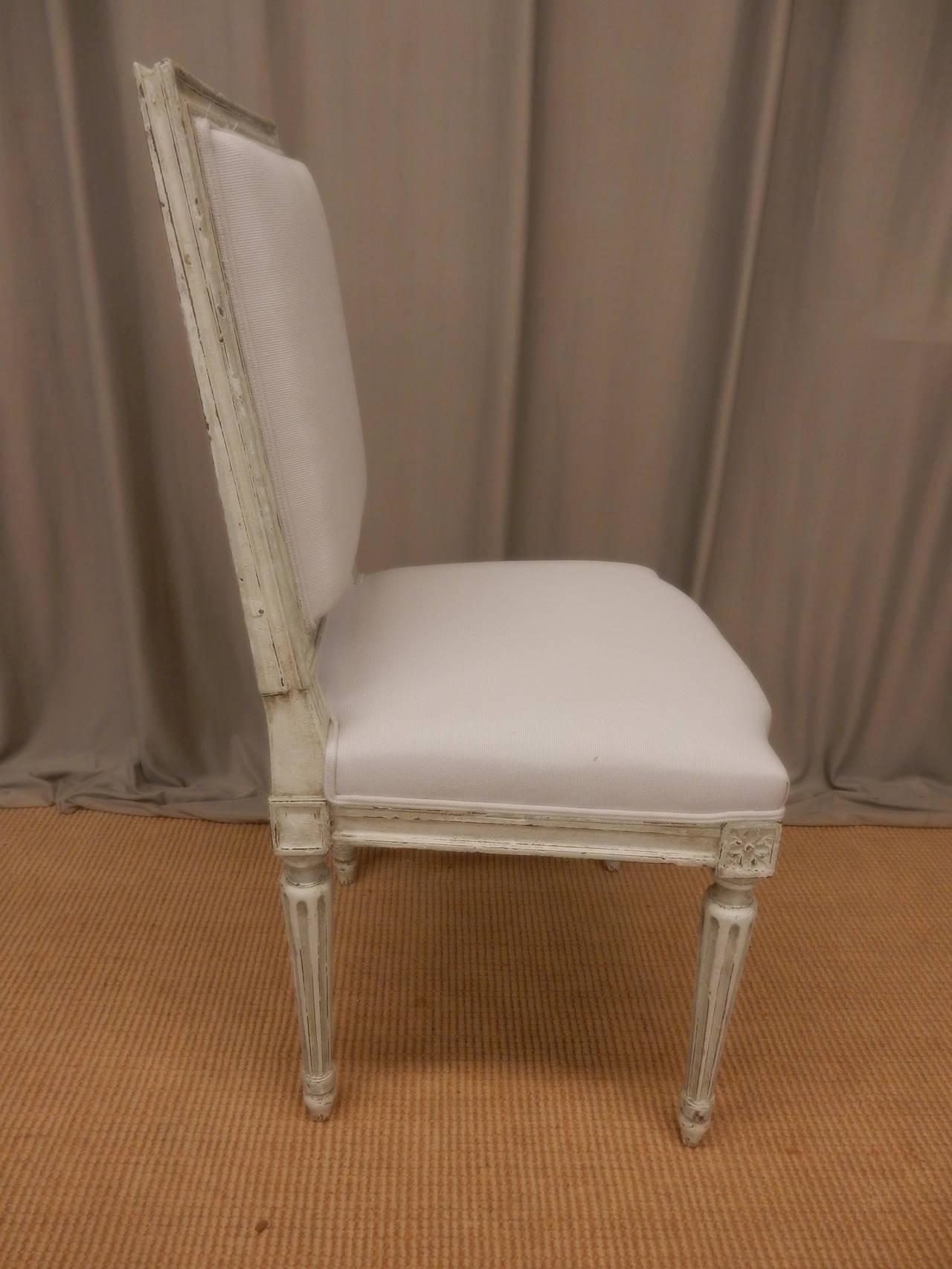 Carved Set of 8 Louis XVI style painted dining chairs For Sale