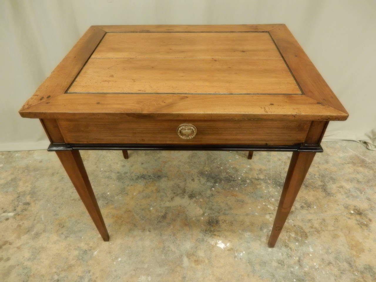 Beautifully restored French Louis XVI walnut side table.  Table is finished on all four sides, has one drawer. It has a warm patina.