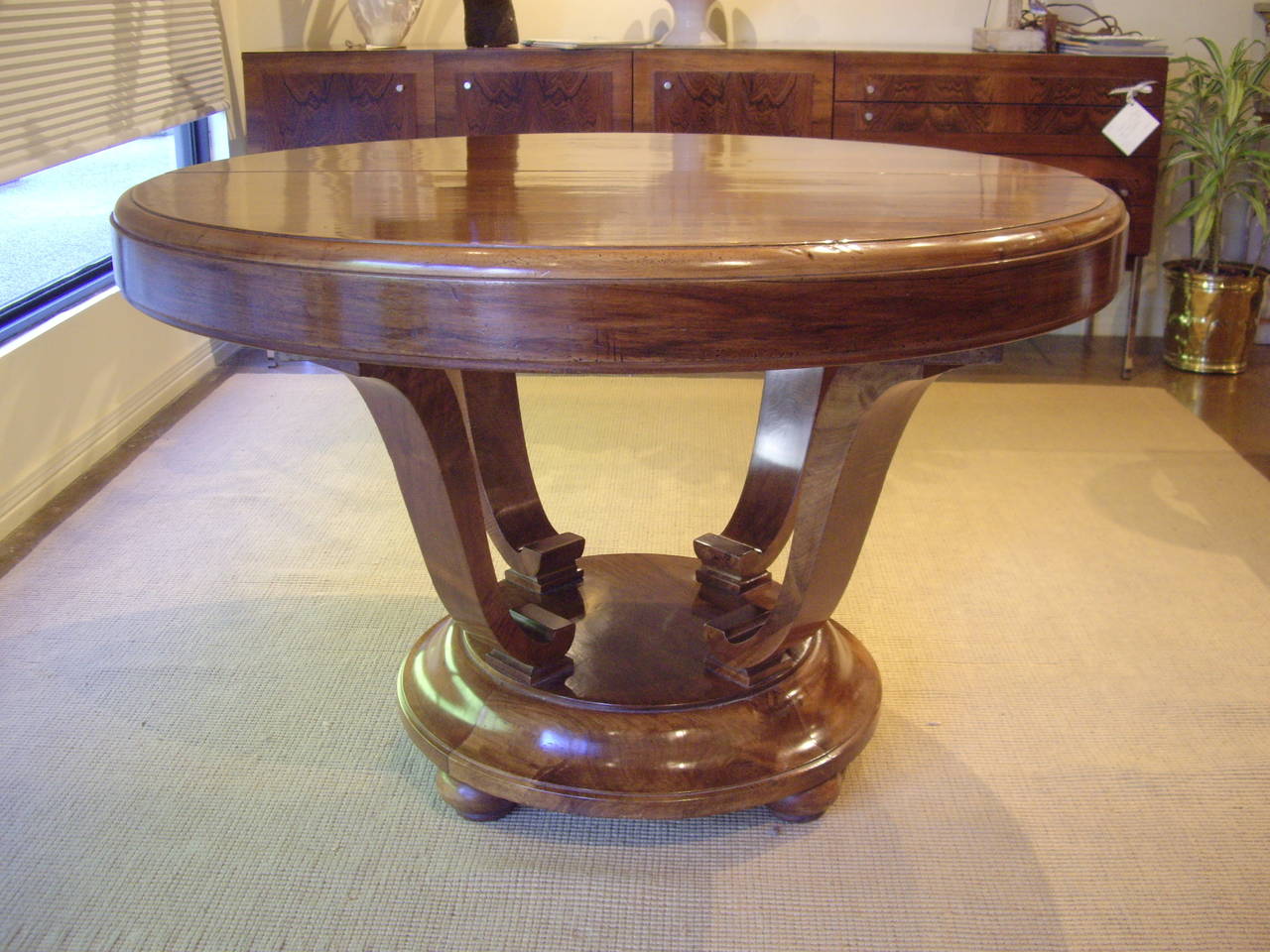 Beautiful French walnut Art Deco Table.  Can be used as a center hall table closed or a dining table open with three leaves.  As a dining table it can seat 8 comfortably.  It has been carefully restored.  It has legs that fold up when closed. 