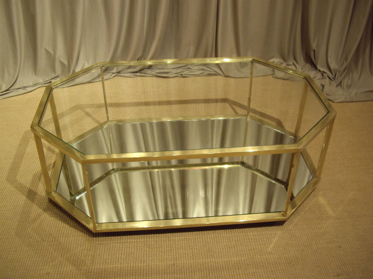 Unusual shaped French vintage brass coffee table. Glass top and shelf.