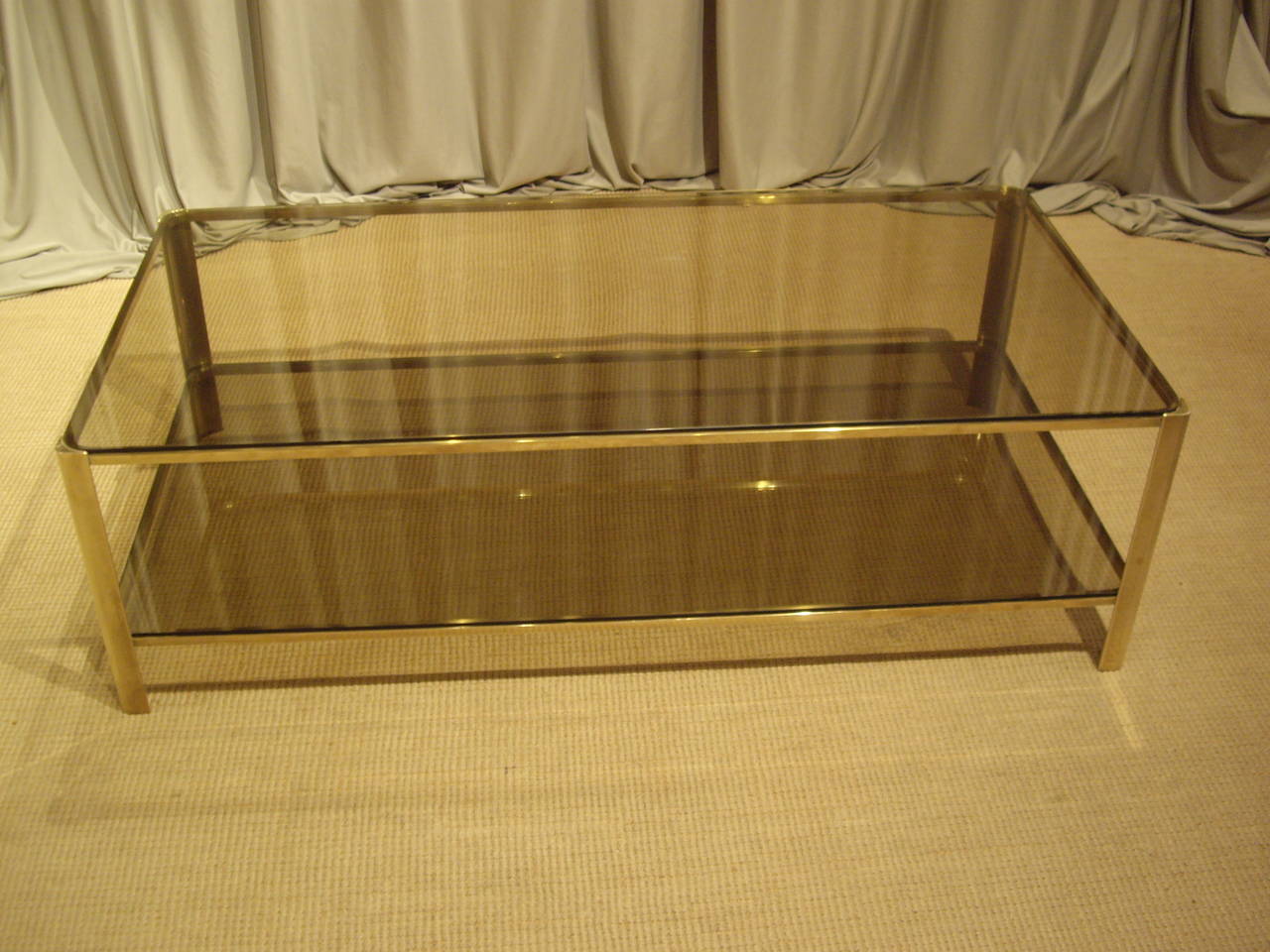 Jacques Quinet designed 1950's bronze coffee table. Smoked glass top and shelf.