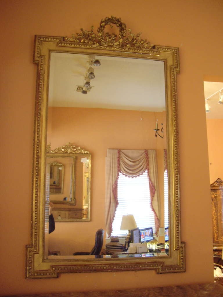 Early 19th century Louis XVI gold gilt mirror with original beveled glass.