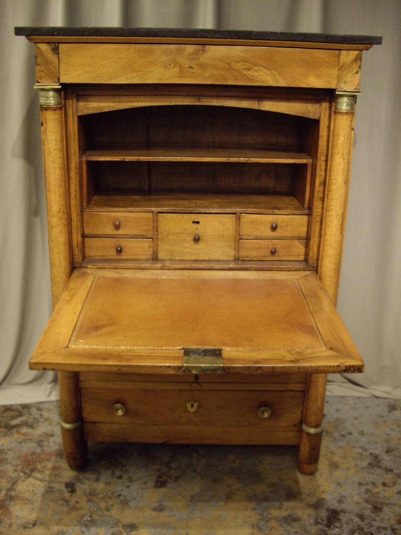 Very nice walnut French Provincial Empire secretaire with fitted interior, leather top and black marble.