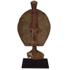 African copper strips on carved wood branch