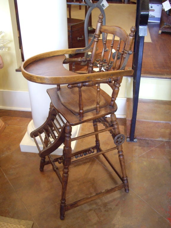 Victorian walnut high chair that folds over and converts in to chair and walker.