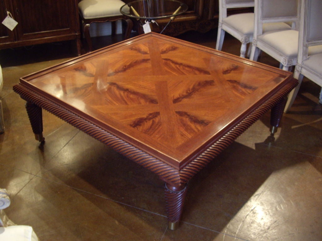 Large vintage Baker's square parquet mahogany coffee table on brass casters.