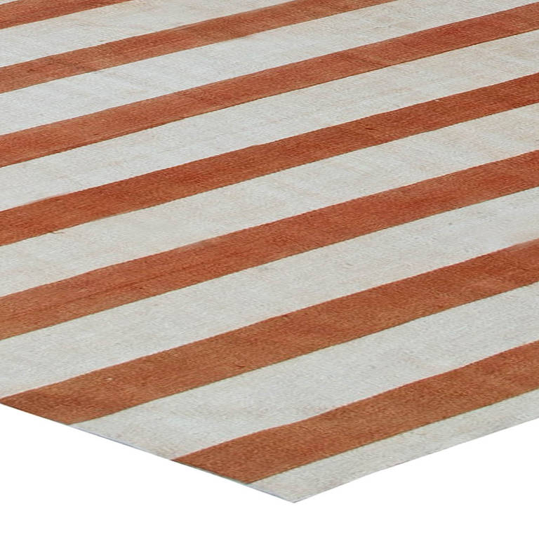 A vintage Indian Dhurrie rug with deep-cinnamon and natural-cotton stripes.