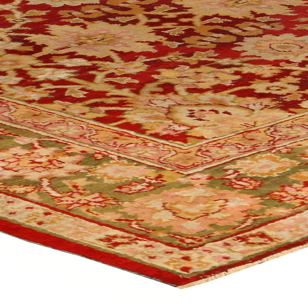 A vibrant late 19th century Indian Amritsar rug, the rich ruby red field with a large-scale pattern of enlarged palmettes, flowering vinery and cloudbands within an olive green palmette border.