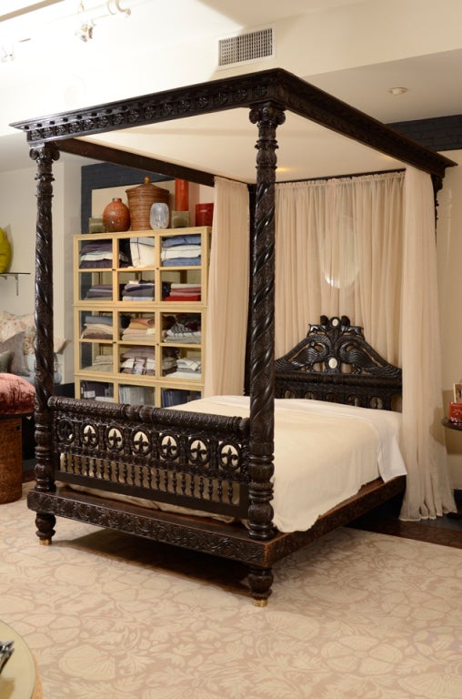 The bed carved throughout with floral and foliate motifs. The fabric/drapes is Rogers & Goffigon.