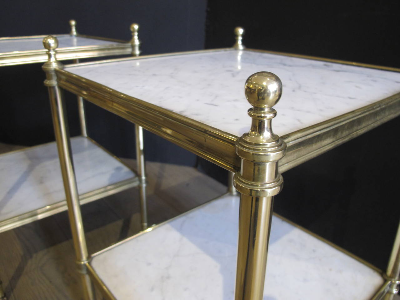 With two marble shelves in very good quality solid cast brass frames. The tables on castors.