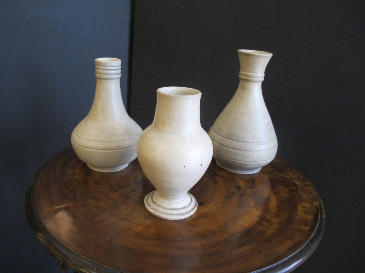 Three white glazed earthenware vases handmade in Martinique. Each with hand-written labels underneath inscribed 'La Martinique'. A former French colony, Martinique has a long history of pottery production on the island. A brickworks clustered around