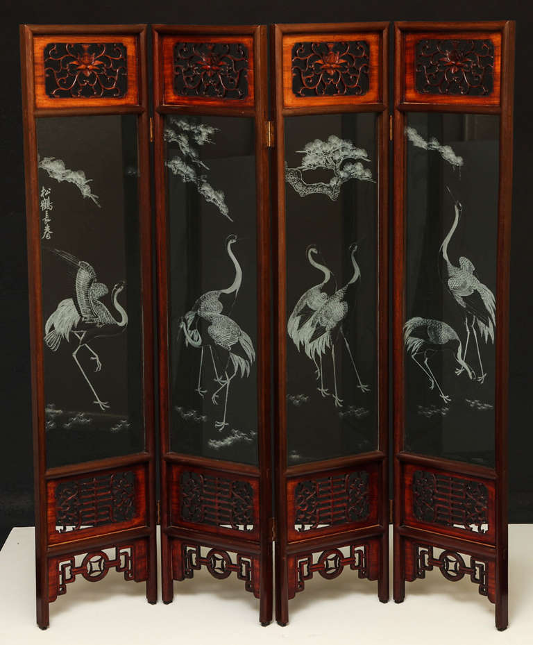 Rosewood and etched glass four panel screen with heron and cherry  blossom scenes.