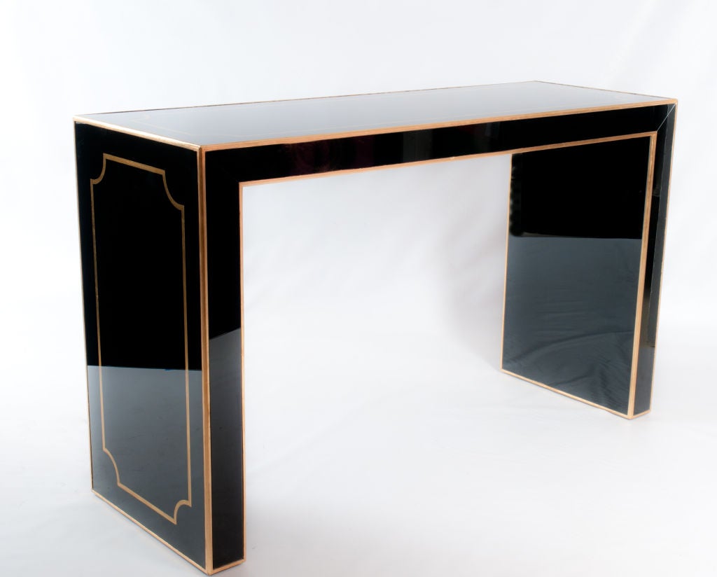 This is a fantastic piece!  Console made of black glass and gilded wood details.