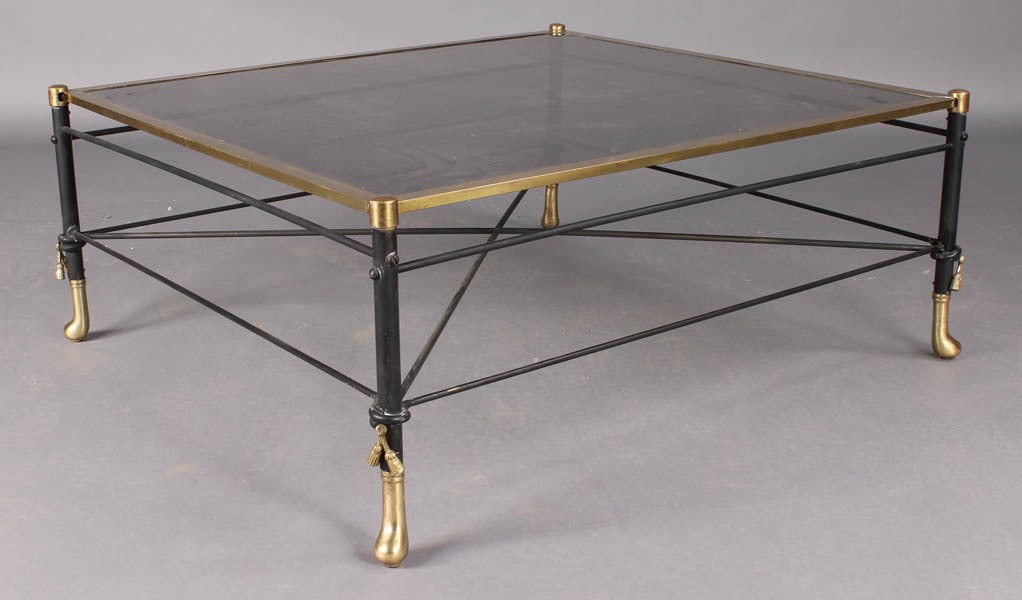 Regency style coffee table with a bronze base that has brass details.  The top is smoked glass.