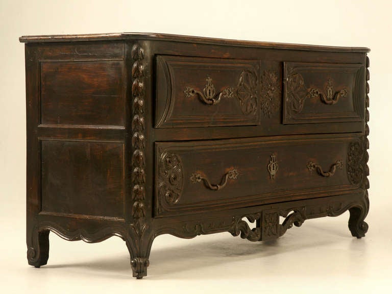 Early old-world craftsmanship paired with solid French walnut make this pantalonnière an amazing home furnishing. Three deep drawers glide effortlessly when you rely on the original hand-forged hardware. The carvings are extensive with bold corners,