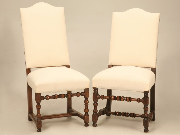 An absolutely amazing and alluring assembled set of eight original antique French Louis XIII dining room chairs. These fine chairs are considered an assembled set because there aren’t even two that match. Each and every one of these chairs are true