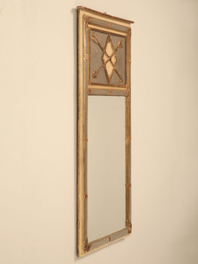 Beautiful antique French Directoire mirror with all original untouched  paint and gilding. This regal mirror has everything you could want, a classic diamond shape with distinctive gilt crossed arrows. Perfect as an accent in any room of the home,