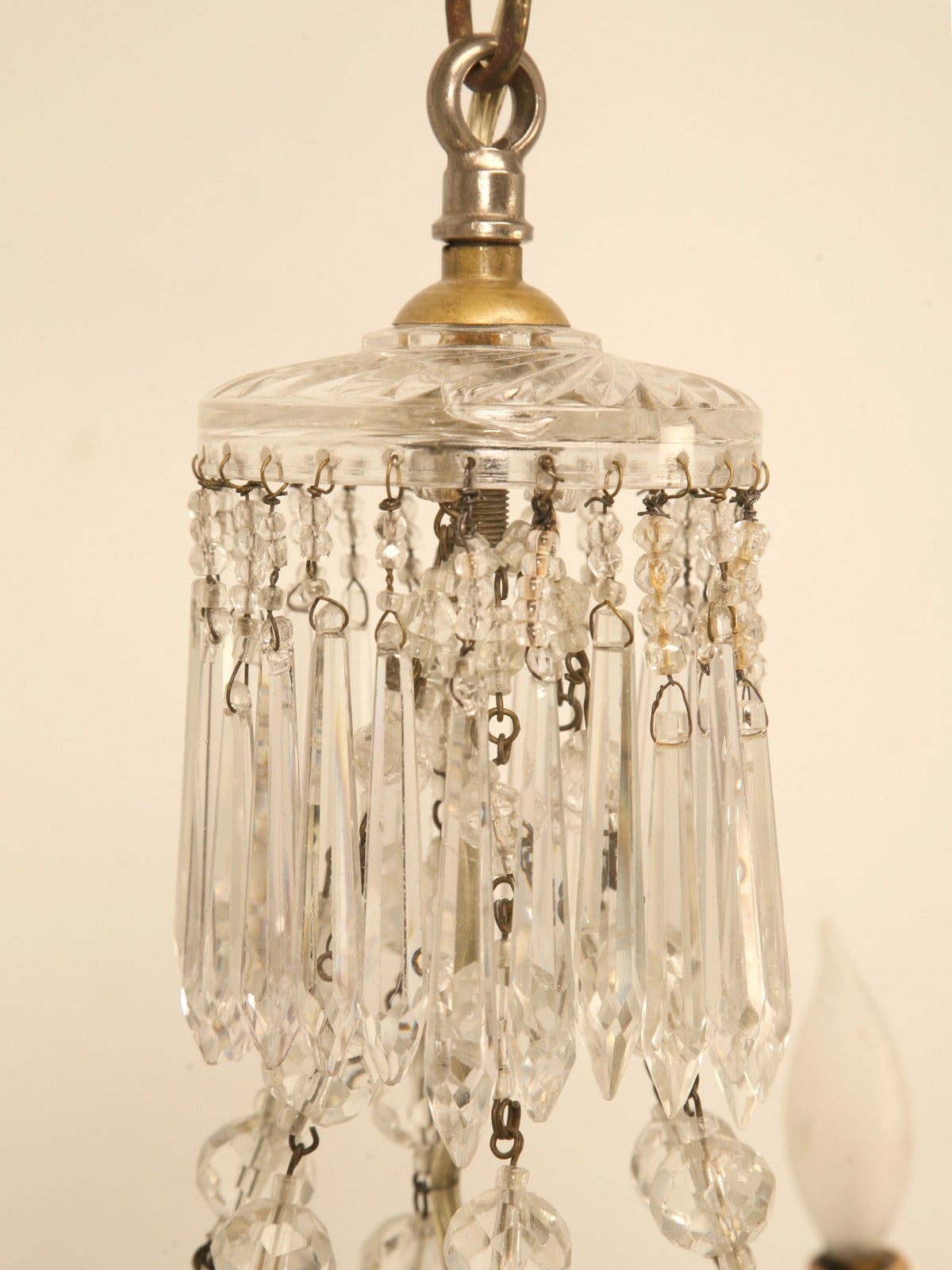 Vintage crystal chandelier that is completely covered in beads. Our best guess would be, Italian made circa 1930s. Appears to be newly rewired and works perfect.
Note: Please look at chipped bottom crystal

The height provided includes the chain