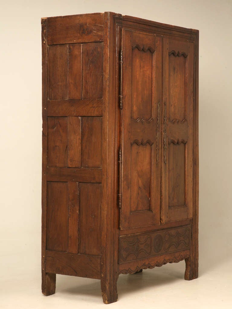 Circa 1650 French cherry armoire from the Brittany region. Truly a cross over piece between the reigns of Louis XIII and Louis XIV. As the Sun King pulled France from the depths of unsuccessful wars, the heavy Louis XIII  style began to evolve into