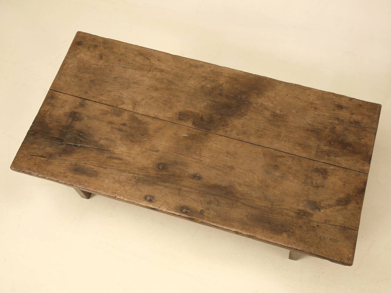 Rustic original French work table with drawer and a wide board top, cut down to coffee table height, circa 1800. It's original 200 year old patina make this antique a must for a family room, weekend retreat, or any other space that could use a bit