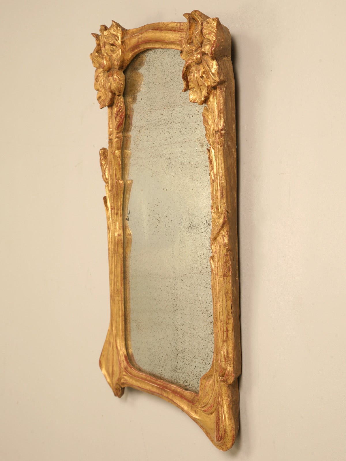 Art Nouveau water gilded mirror with its original glass, circa 1888-1910. The hand-carved wooden frame is in unbelievably good condition and upon close inspection does not require any restoration what-so-ever.