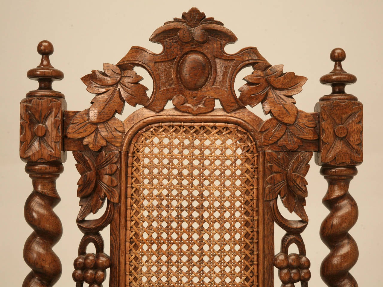 French oak barley twist side chair with a cane seat in a grape motif, circa 1890-1910. Although structurally very sound, if you look closely it is slightly out of plumb, but functions quite well.