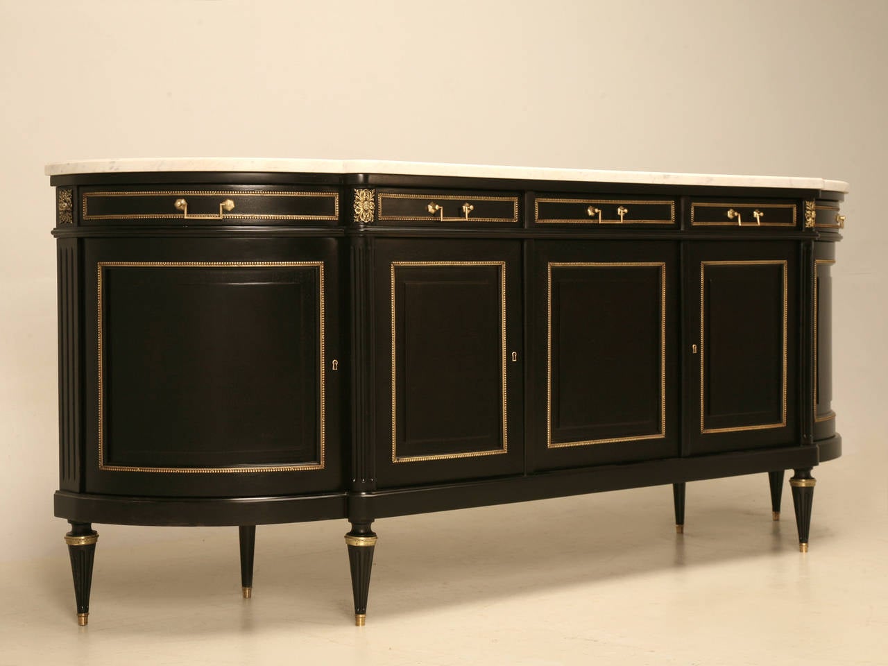 Vintage French ebonized mahogany buffet, complimented by a beautiful white marble top. Our workshop hand scraped and hand sanded the entire sideboard to the bare wood, then applied layer upon layer on dark stains to emulate an original 19th ebonized