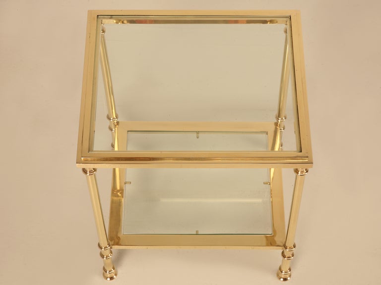 With clean styling, and up to date features, this single solid brass** and glass two tier table is just right for so many applications. Awesome as a night stand in the bedroom, as a unique cocktail table, or cozied between two chairs in a grand
