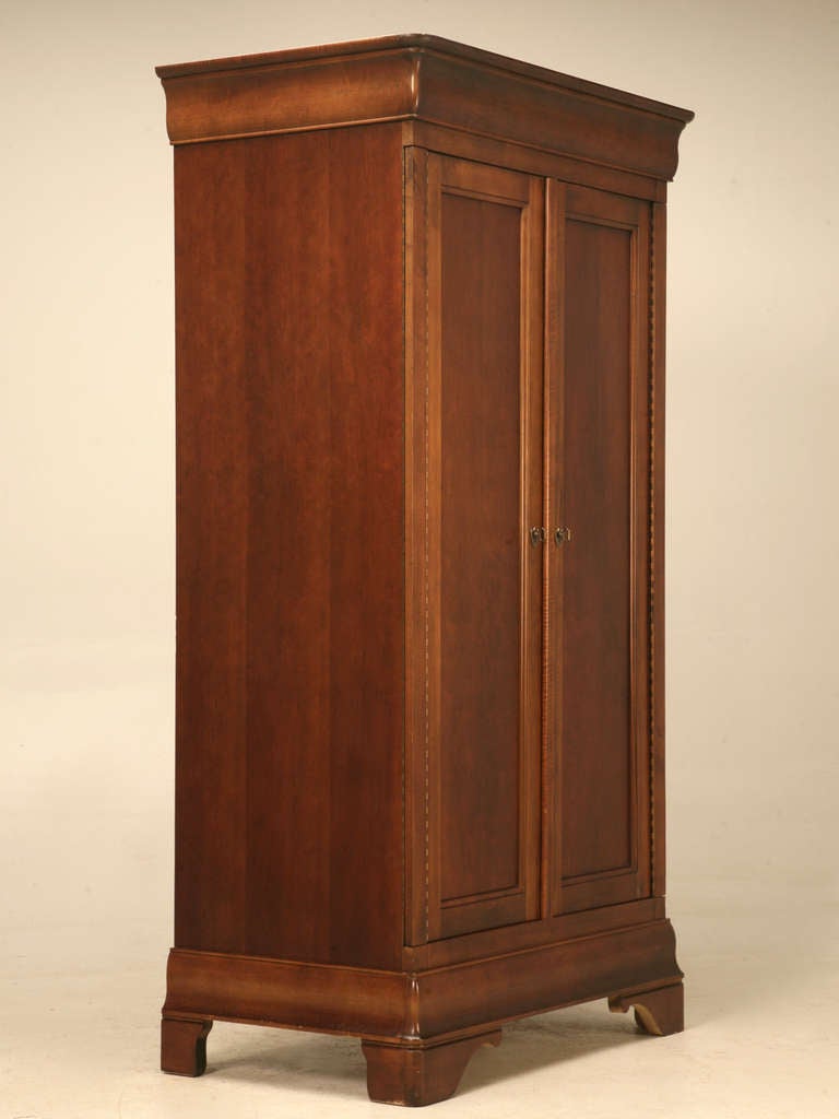 Vintage American cherry wood armoire in a Louis Philippe style. 
The Mount Airy Furniture Company was formed in 1895 by J. F. Yokley, C. R. Merritt and E. H. Kochtitzky and it manufactured case goods including bedroom furniture, executive office