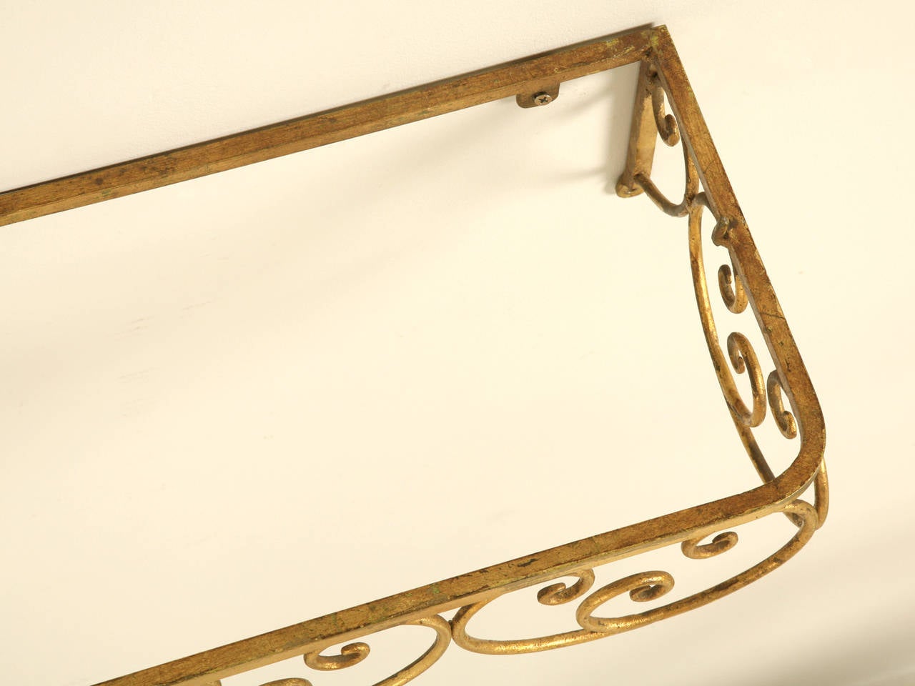 Italian circa 1940s wall-mounted console or shelf, that just happens to match our dressing room chair. Nicely gilded and scrolled steel frame ready for a glass, or marble top.