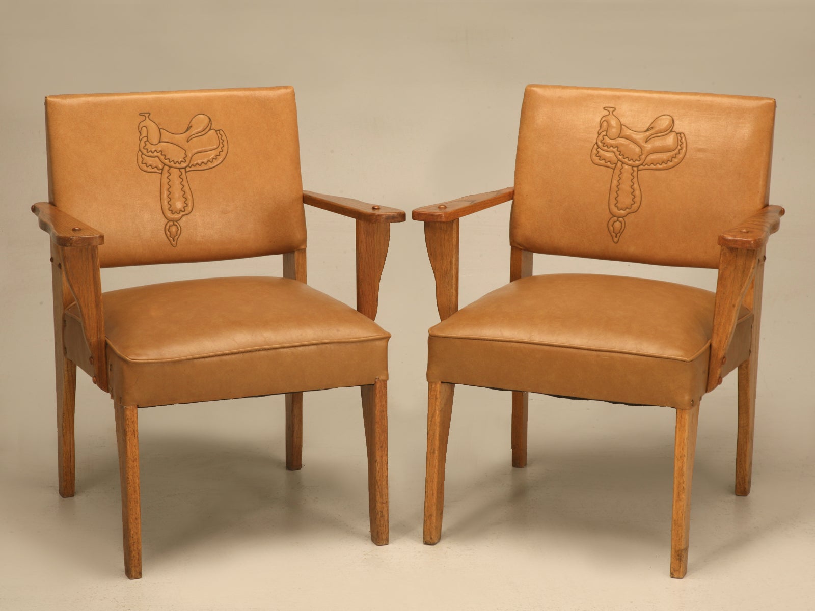 Magnificent Pair of Original "Ranch Oak" Cowboy Arm Chairs w/Saddle Decoration