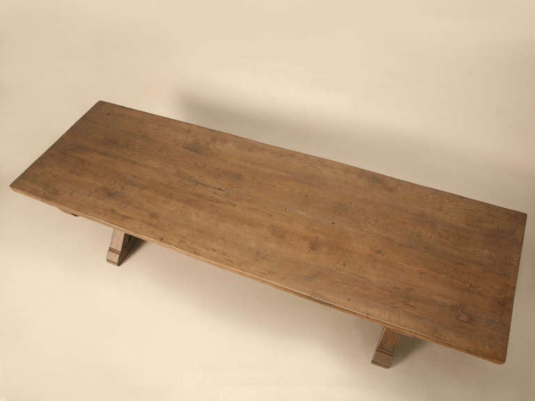 This table is an authentic copy of an 18th century French farm table and was made by the craftsmen here in our in-house workshop in Chicago. It was made from rift cut white oak boards, with custom edging as specified by the client. The aged oak is