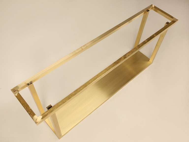 Custom-made console table base. This base, in brushed brass, was designed to take a marble top measuring 96\