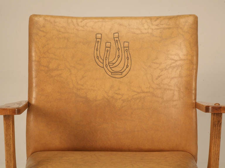 Hey there pardner!! You'd best saddle up so you don't miss this incredible cowboy club chair branded with a double horseshoe decoration. Designed in the 1930's, Ranch Oak furniture filled a void for stylish but, functional furniture that went along